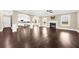 Spacious living room with hardwood floors, fireplace and view of the kitchen at 5950 Hidden Ridge Ct, Cumming, GA 30028