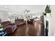 Open-concept living room with hardwood floors, a fireplace, and neutral color palette and access to kitchen at 5950 Hidden Ridge Ct, Cumming, GA 30028