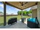 A covered patio featuring outdoor furniture, a fire pit table, and a grill, perfect for entertaining guests at 5950 Hidden Ridge Ct, Cumming, GA 30028