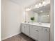 Bright bathroom featuring double sinks, a large mirror, and a glass enclosed shower at 6372 Rosetta Sw Dr, Atlanta, GA 30331