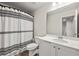 Updated bathroom with striped shower curtain, white vanity, and modern fixtures at 6372 Rosetta Sw Dr, Atlanta, GA 30331