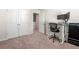 Clean, carpeted bedroom with a modern computer desk, workspace, and closet at 6372 Rosetta Sw Dr, Atlanta, GA 30331