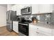 Granite counters and stainless appliances shine in this updated kitchen at 6372 Rosetta Sw Dr, Atlanta, GA 30331
