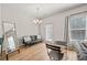 Cozy living room with wood floors, neutral paint, and large window at 6372 Rosetta Sw Dr, Atlanta, GA 30331