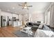 Stylish living room featuring hardwood floors, modern furniture, and an open layout to the kitchen at 6372 Rosetta Sw Dr, Atlanta, GA 30331