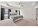 Spacious main bedroom with tray ceiling, carpet, and large bed at 6372 Rosetta Sw Dr, Atlanta, GA 30331