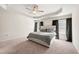 Main bedroom features a tray ceiling, neutral carpet, and an oversized bed at 6372 Rosetta Sw Dr, Atlanta, GA 30331
