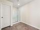 Tiled bathroom featuring a white shower with glass doors and tile flooring at 6372 Rosetta Sw Dr, Atlanta, GA 30331