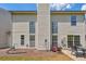 Exterior image of the backyard of home with a small table and chairs on a concrete patio and grassy area at 1703 Bentridge Nw Dr, Kennesaw, GA 30144