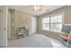 Well-lit bedroom with a large window, neutral walls, and open space at 1703 Bentridge Nw Dr, Kennesaw, GA 30144