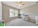 Bright bedroom featuring a ceiling fan and a large window for natural light and fresh air at 1703 Bentridge Nw Dr, Kennesaw, GA 30144