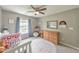 Inviting bedroom with a crib, dresser, and a window, creating a cozy atmosphere at 1703 Bentridge Nw Dr, Kennesaw, GA 30144