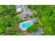 Aerial image of a community pool surrounded by mature trees, lush landscaping, and parking at 1703 Bentridge Nw Dr, Kennesaw, GA 30144
