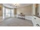 Bright living room with a bay window, chandelier, and elegant white wainscoting at 1703 Bentridge Nw Dr, Kennesaw, GA 30144