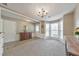 Inviting living room with a bay window, wood floors, carpet, and classic chandelier lighting at 1703 Bentridge Nw Dr, Kennesaw, GA 30144