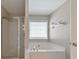Relaxing main bathroom with a separate shower and a luxurious soaking tub at 1703 Bentridge Nw Dr, Kennesaw, GA 30144