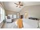 Sun-filled main bedroom with chair, dressers, and an ensuite bathroom at 1703 Bentridge Nw Dr, Kennesaw, GA 30144