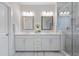 Modern bathroom with double vanity, framed mirrors, and a glass-enclosed walk-in shower at 2062 Cortland Rd, Milton, GA 30009