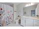 Bright bathroom with floral shower curtain, white vanity, and updated fixtures at 2062 Cortland Rd, Milton, GA 30009