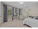 Bright bedroom includes a large window, plush carpet, and stylish decor for a serene retreat at 2062 Cortland Rd, Milton, GA 30009