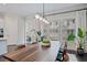 Dining room with views, long table, and modern lighting at 2062 Cortland Rd, Milton, GA 30009