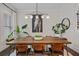 Dining room with a long table, modern lighting, and stylish decor at 2062 Cortland Rd, Milton, GA 30009