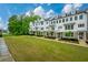 Manicured townhome lawns contribute to the community's allure, with lush greenery and tree lined streets at 2062 Cortland Rd, Milton, GA 30009