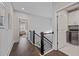 Hallway showcasing dark hardwood floors, white walls, and access to a bedroom and laundry room at 2062 Cortland Rd, Milton, GA 30009
