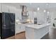 Bright kitchen features white cabinets, stainless steel appliances, and a large island at 2062 Cortland Rd, Milton, GA 30009