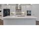 Open kitchen with white cabinets, stainless steel appliances, and a center island at 2062 Cortland Rd, Milton, GA 30009