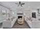 Spacious living room with hardwood floor, stone fireplace, large windows, and comfortable sofas at 2062 Cortland Rd, Milton, GA 30009