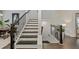 Elegant staircase with dark wood railings and neutral colored walls leading to upper and lower levels at 2062 Cortland Rd, Milton, GA 30009