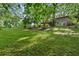 Lush, green backyard with mature trees and an elevated deck, providing privacy and a natural setting at 2337 Elmwood Se Cir, Atlanta, GA 30339