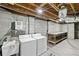 Functional basement laundry area featuring a washer, dryer, and utility sink, plus open storage, and unfinished ceiling at 2337 Elmwood Se Cir, Atlanta, GA 30339