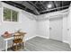 Versatile basement space with a desk, chair, and natural light, ideal for a home office or study area at 2337 Elmwood Se Cir, Atlanta, GA 30339