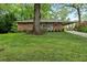 Charming brick home featuring a well-manicured lawn and a convenient covered carport at 2337 Elmwood Se Cir, Atlanta, GA 30339