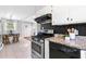 Bright kitchen with stainless steel appliances, stone countertops, and access to the dining area at 2337 Elmwood Se Cir, Atlanta, GA 30339
