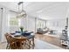Open-concept living and dining area with neutral decor, modern lighting, and hardwood floors at 2337 Elmwood Se Cir, Atlanta, GA 30339