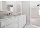 This bathroom has a double sink vanity with a stone countertop and white cabinets at 2529 Ryne St, Atlanta, GA 30318