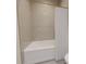 Clean, modern bathroom with a white tub, shower curtain, and neutral-toned herringbone tile at 324 Treble Way, Alpharetta, GA 30009