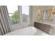 Serene bathroom with a freestanding tub, large window, and modern vanity offering a spa-like experience at 324 Treble Way, Alpharetta, GA 30009