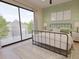 Comfortable bedroom with a black metal bed frame, neutral colors, and sliding glass doors to an outdoor space at 324 Treble Way, Alpharetta, GA 30009