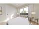 Cozy bedroom features a comfortable bed, soft lighting, and a large window offering a relaxing space at 324 Treble Way, Alpharetta, GA 30009