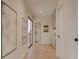 Bright hallway featuring hardwood floors, art, and an open doorway, creating a welcoming transition space at 324 Treble Way, Alpharetta, GA 30009