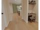 Bright hallway view leading to an open kitchen and dining area with hardwood floors at 324 Treble Way, Alpharetta, GA 30009