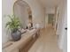 Elegant hallway with a wooden bench, decorative lamps, arched mirror, and hardwood floors at 324 Treble Way, Alpharetta, GA 30009