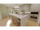 Open kitchen with an island, bar seating, modern appliances, and a dining area at 324 Treble Way, Alpharetta, GA 30009