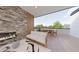 Relaxing patio area with a fireplace, comfortable seating, and an outdoor dining set with beautiful views at 324 Treble Way, Alpharetta, GA 30009