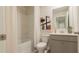 Well-lit bathroom features a combined tub and shower, sleek toilet, and modern vanity at 4960 Jatoba Rd, Acworth, GA 30101
