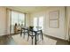Bright dining area with dark table, white chairs, modern art, and lots of natural light at 4960 Jatoba Rd, Acworth, GA 30101